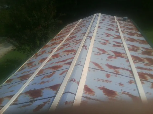Rusted metal roof panels with new wood purlins before replacement — Storm Damage Roof Repair in Summersville by Roofing Brothers